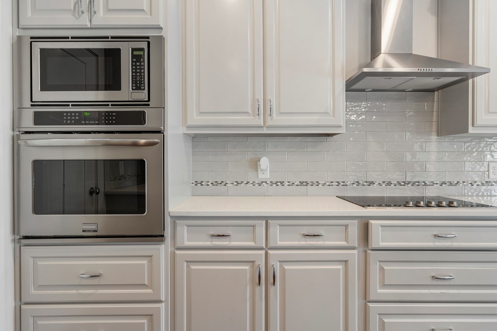 7044 Spring Walk Drive Columbus, GA 31904 - Photo 10 of 41 a kitchen with granite countertop white cabinets stainless steel appliances and a fireplace
