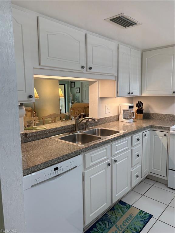 5841 Rattlesnake Hammock Road, Unit I203 Naples, FL 34113 - Photo 7 of 24 a kitchen with stainless steel appliances granite countertop a sink stove and cabinets