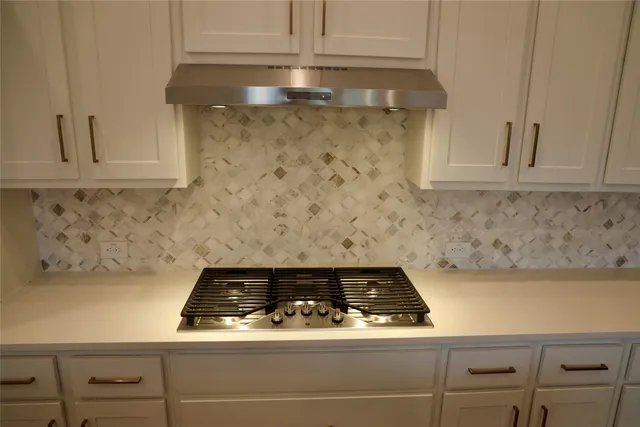 a close view of a stove top oven sitting inside of a kitchen
