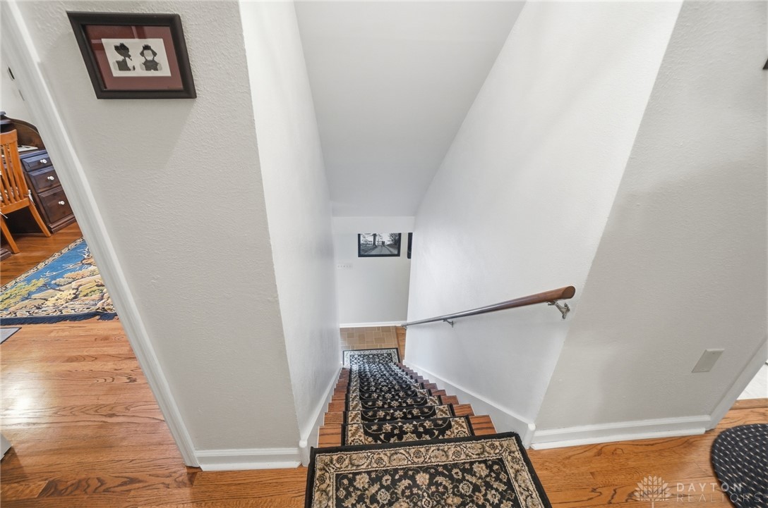 4170 Johnson Road Springfield, OH 45502 - Photo 33 of 54 d stair runner create an inviting descent into the lower level.