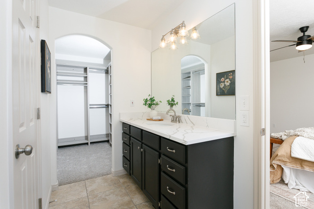 1742 Renaissance Way Springville, UT 84663 - Photo 10 of 23 Vanity with dark cabinetry and a white countertop, featuring a single basin and a chrome faucet