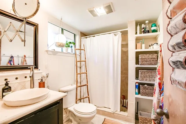 a bathroom with a sink toilet and shower