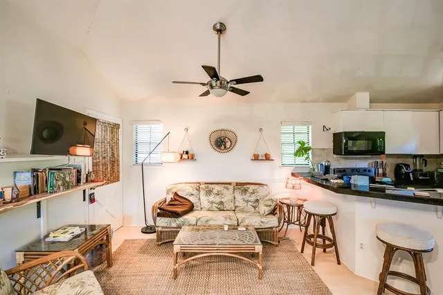 a living room with furniture a rug and a flat screen tv
