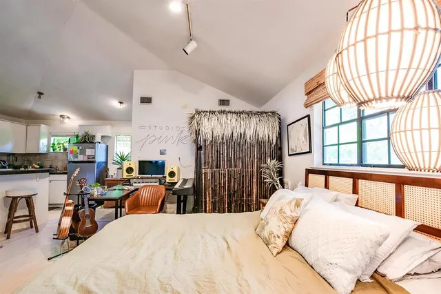 a bed room with a bed and a large window