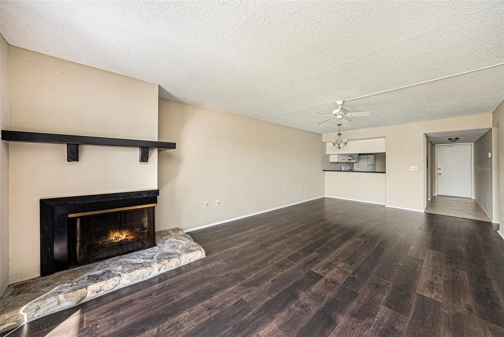 141 Lakeview Way, Unit 141 Oldsmar, FL 34677 - Photo 11 of 28 a view of an empty room with wooden floor fireplace and a window
