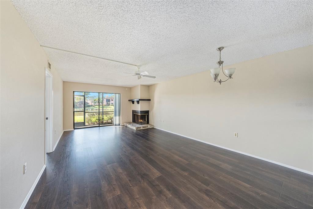 141 Lakeview Way, Unit 141 Oldsmar, FL 34677 - Photo 12 of 28 wooden floor in an empty room with a window
