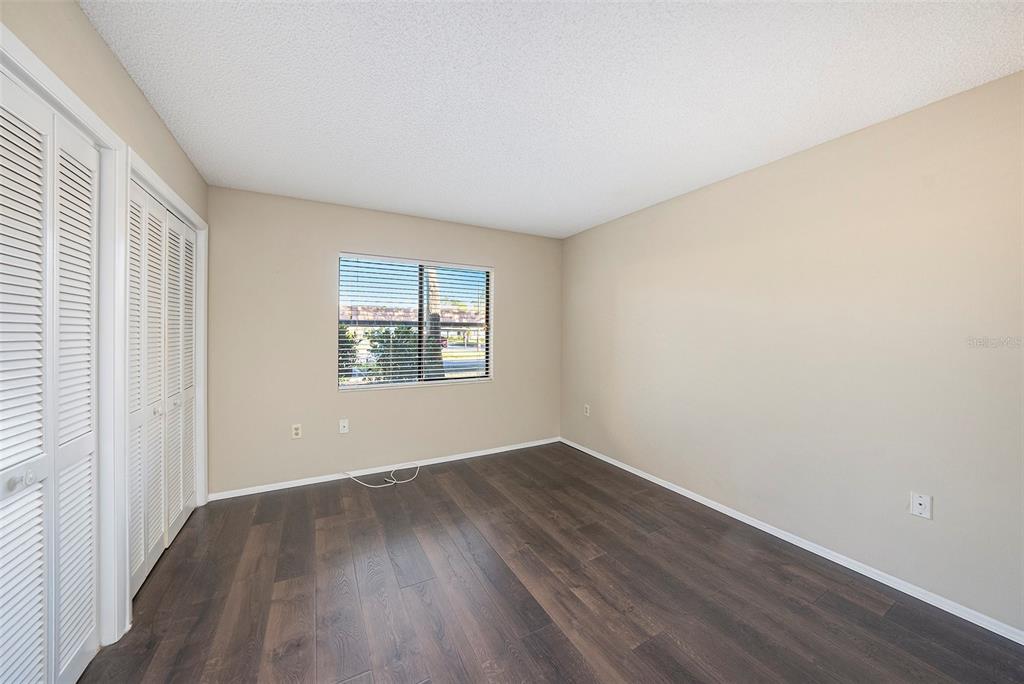141 Lakeview Way, Unit 141 Oldsmar, FL 34677 - Photo 21 of 28 an empty room with wooden floor and windows