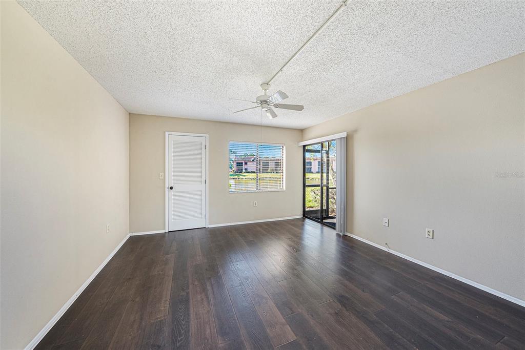 141 Lakeview Way, Unit 141 Oldsmar, FL 34677 - Photo 22 of 28 a view of an empty room with window and wooden floor