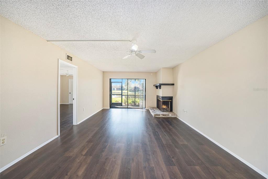 141 Lakeview Way, Unit 141 Oldsmar, FL 34677 - Photo 24 of 28 an empty room with wooden floor and windows