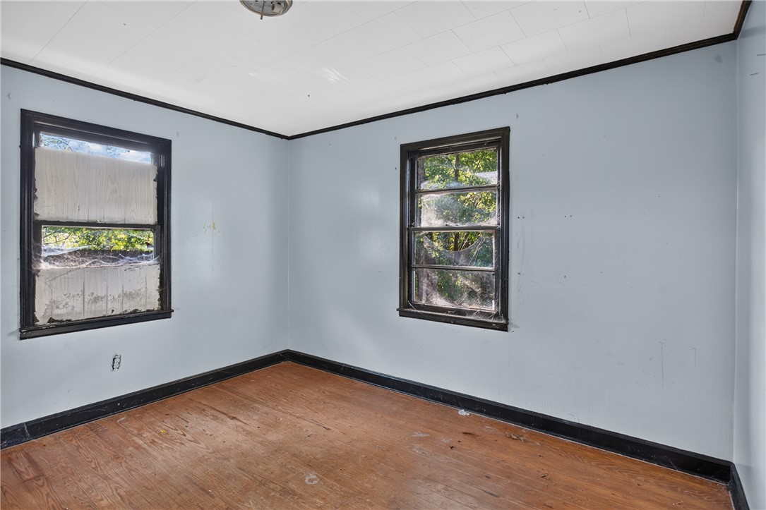 676 Marcengill Road Westminster, SC 29693 - Photo 19 of 32 Natural light pours through dual windows highlighting the original hardwood flooring in this cozy bedroom.