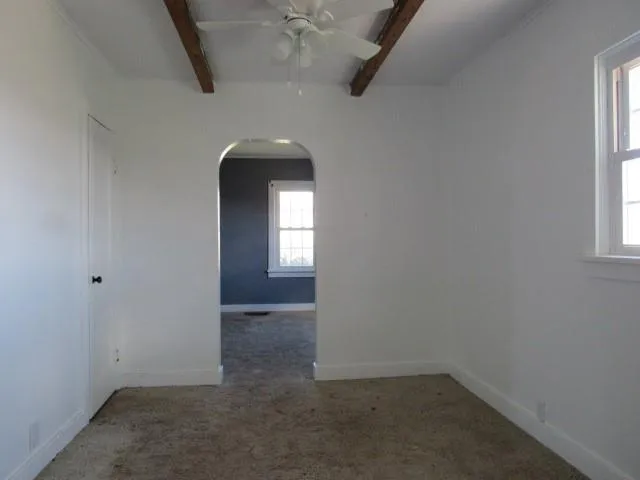 an empty room with windows and entrance