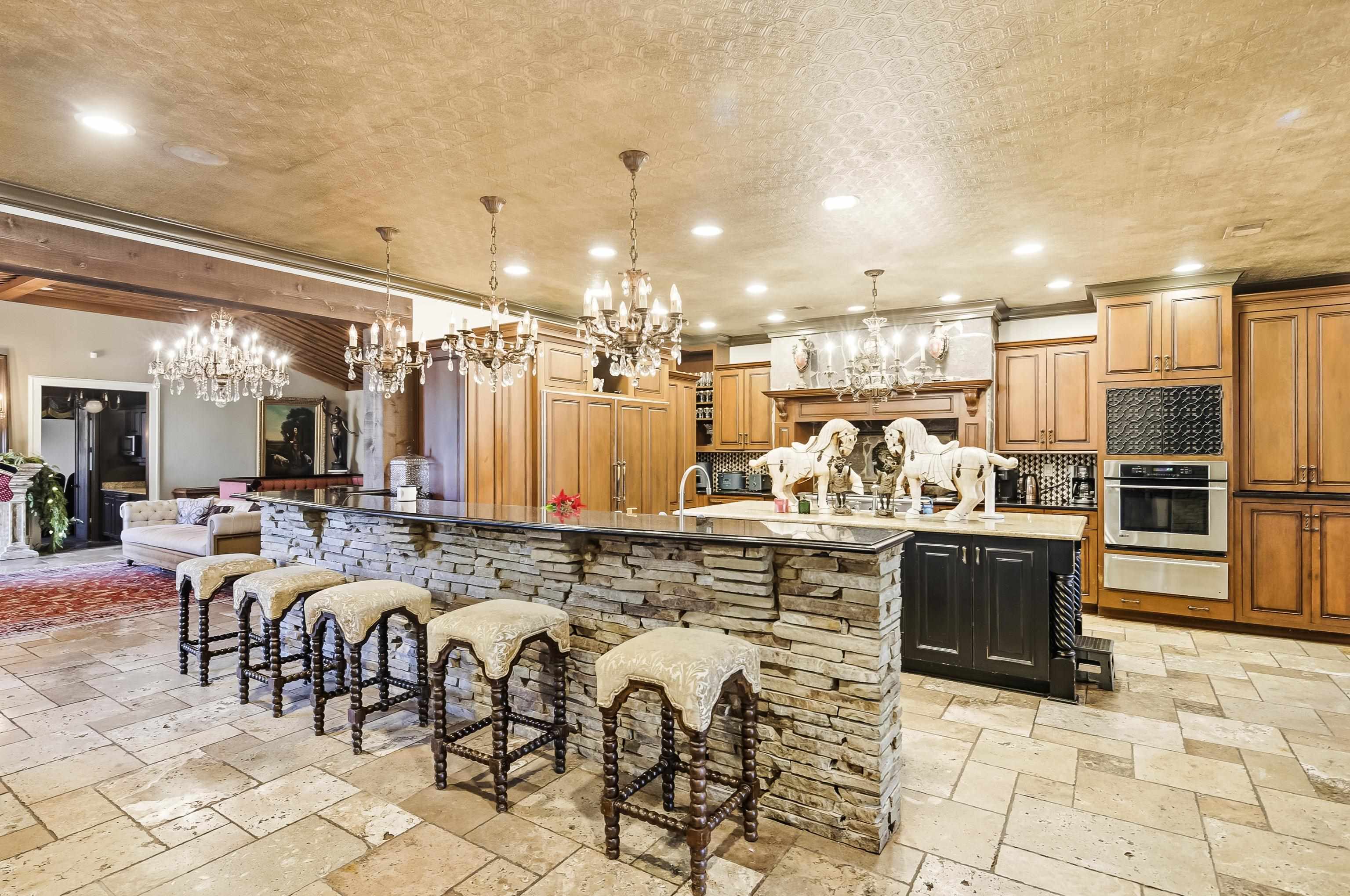 5110 Reynolds Road Collierville, TN 38017 - Photo 11 of 40 Kitchen with a chandelier, a kitchen bar, recessed lighting, pendant lighting, and stainless steel oven