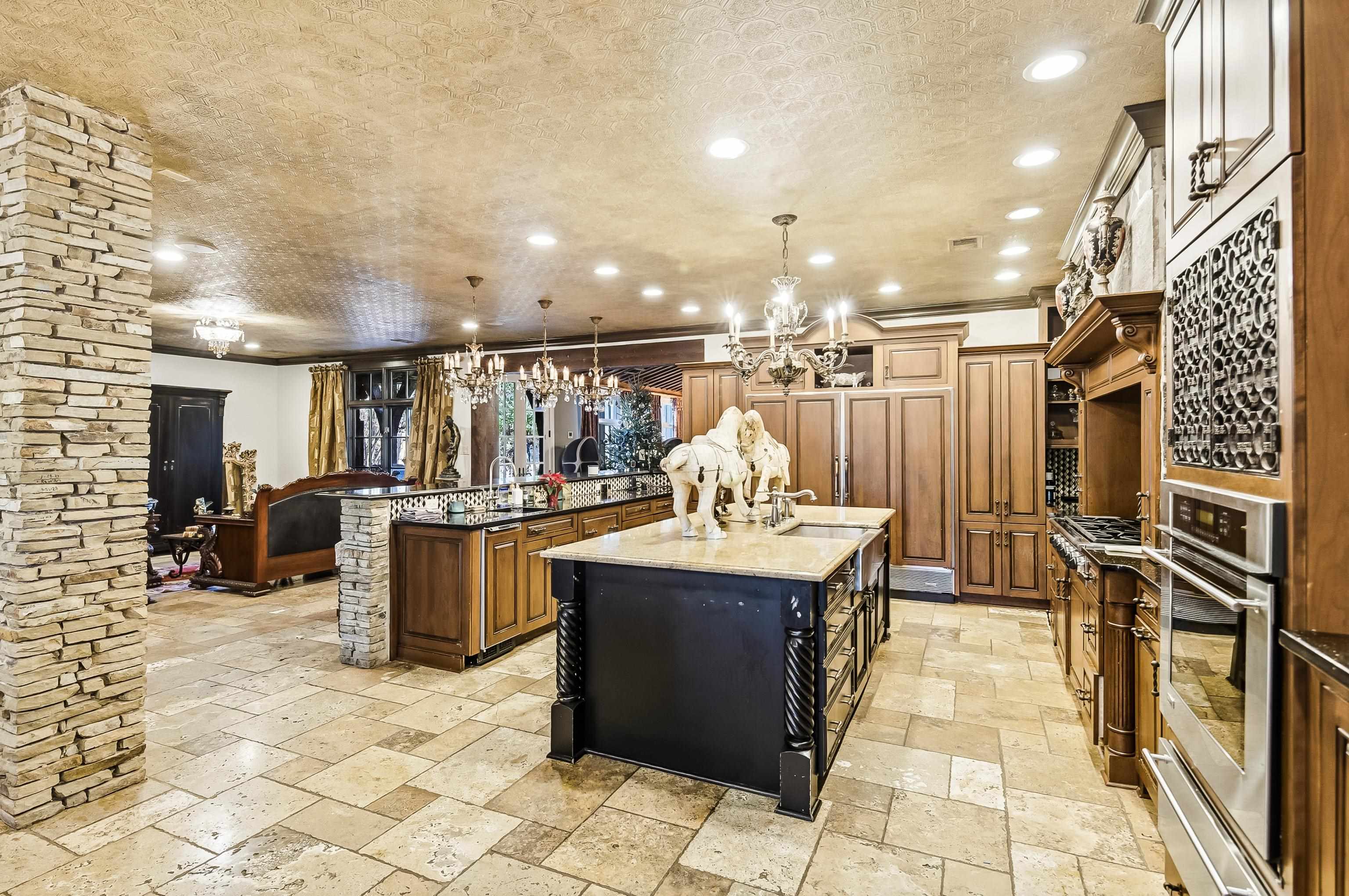 5110 Reynolds Road Collierville, TN 38017 - Photo 12 of 40 Kitchen with dark stone counters, decorative light fixtures, brown cabinets, recessed lighting, and stainless steel oven