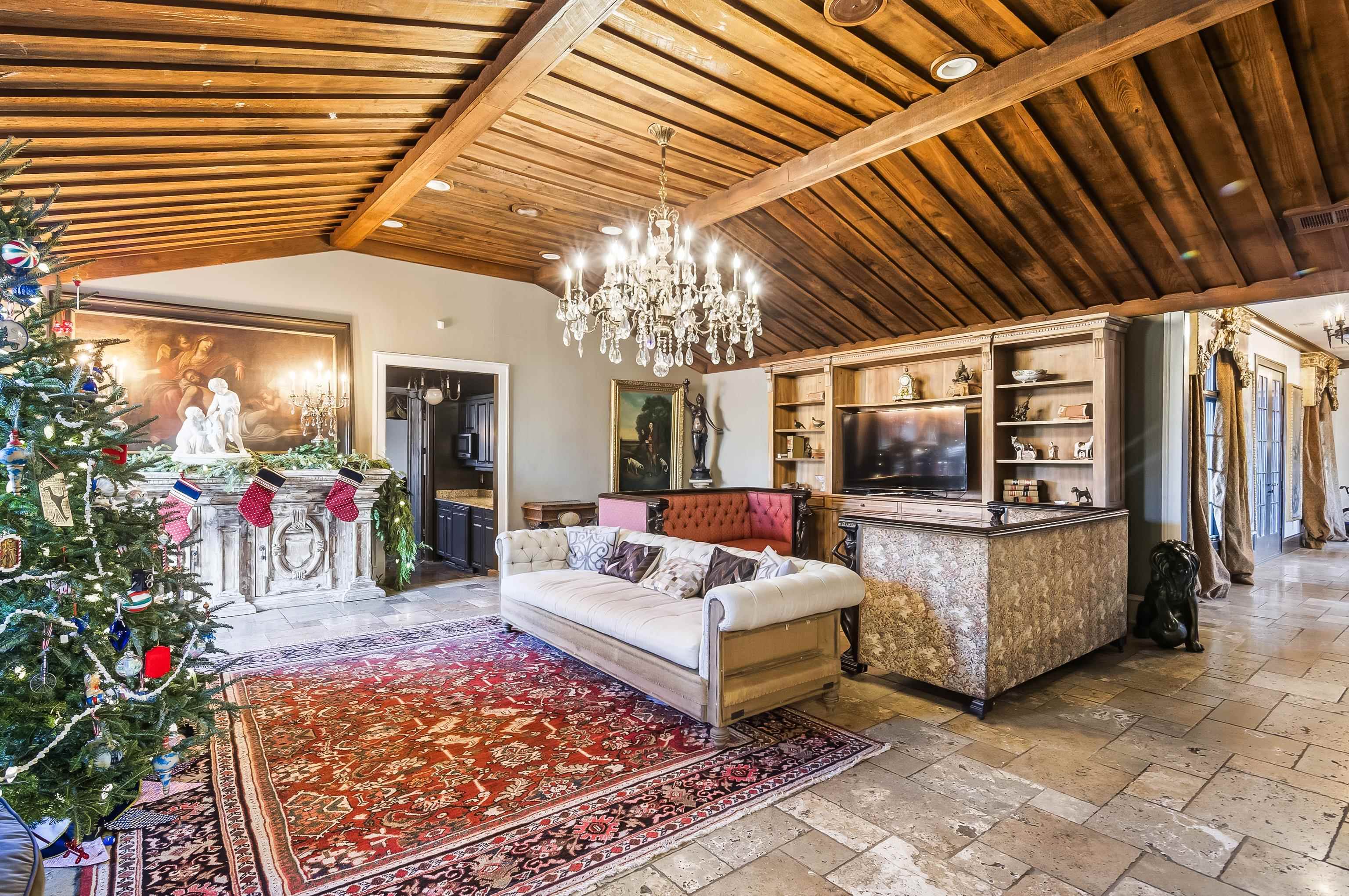 5110 Reynolds Road Collierville, TN 38017 - Photo 13 of 40 Living room featuring a chandelier, stone tile flooring, and wood ceiling