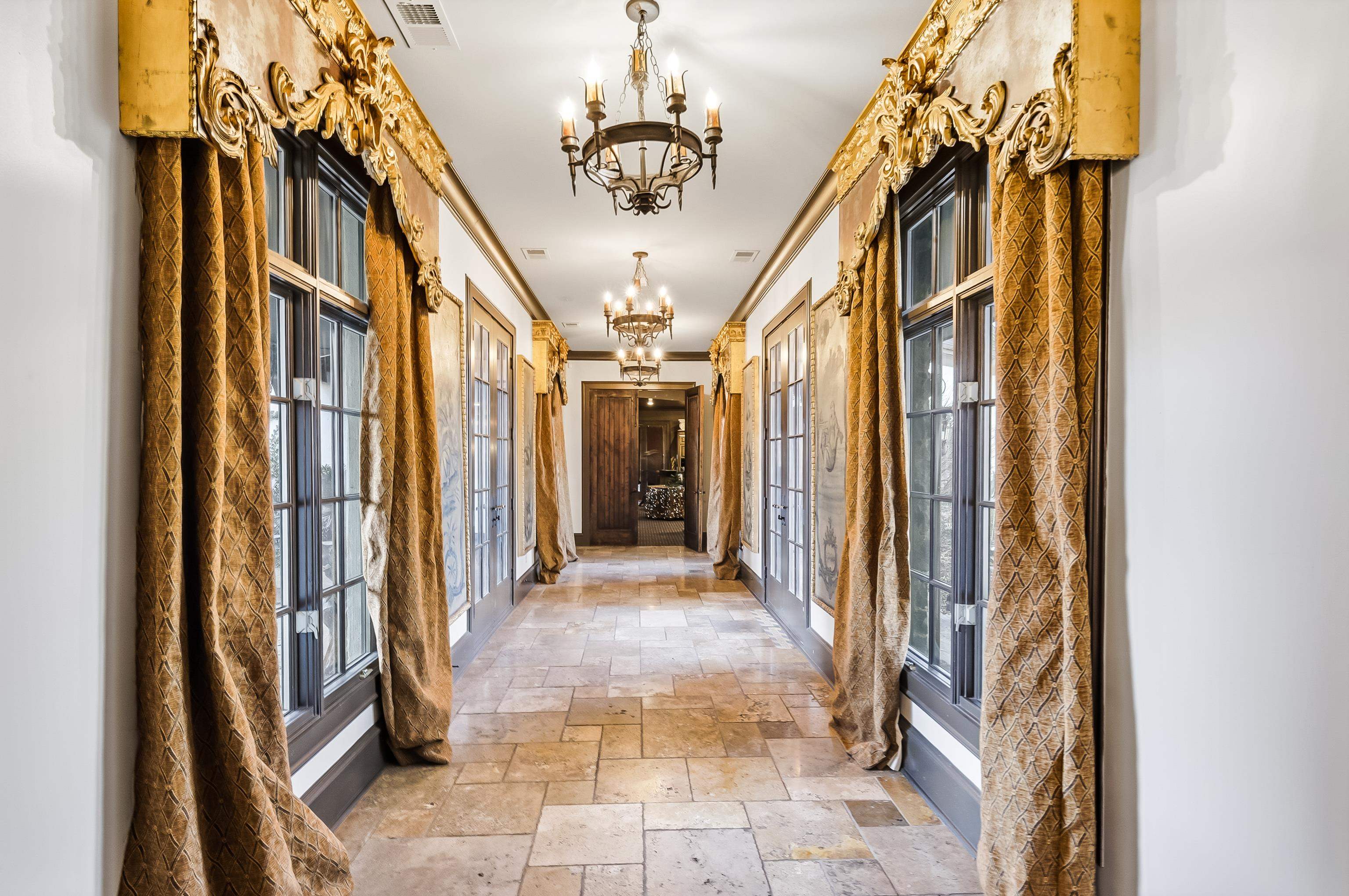 5110 Reynolds Road Collierville, TN 38017 - Photo 17 of 40 Hallway featuring a chandelier, stone tile flooring, plenty of natural light, and french doors