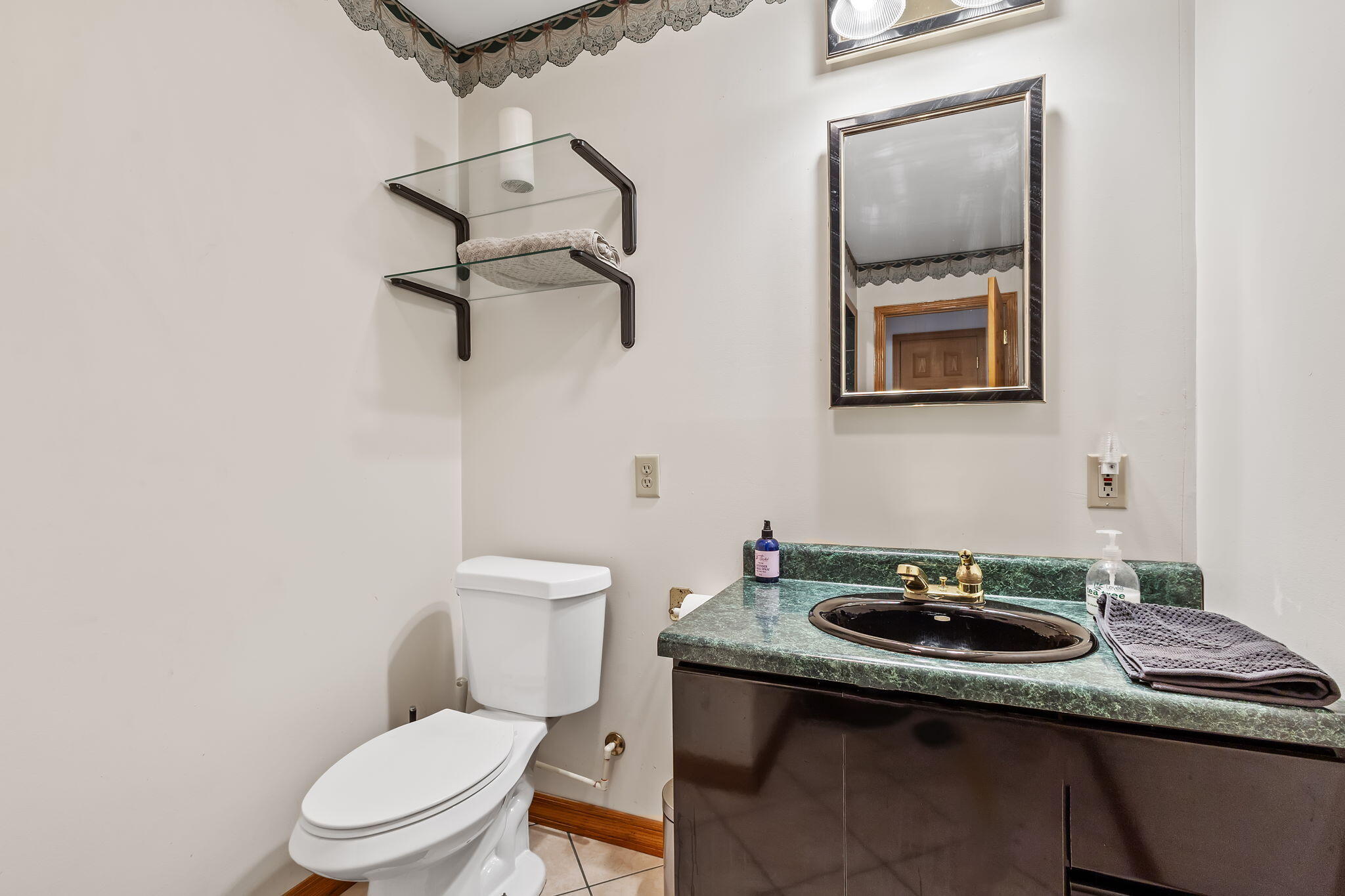 2549 East 1100 North Demotte, IN 46310 - Photo 17 of 74 a bathroom with a toilet a sink and mirror