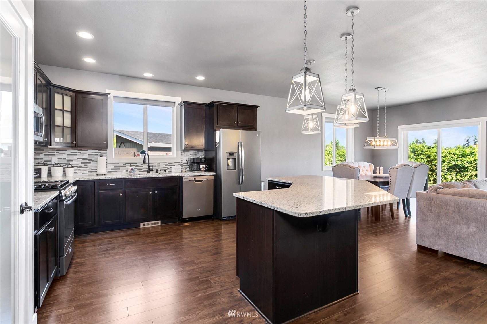 1002 Ridge Lane Everson, WA 98247 - Photo 6 of 38 a kitchen with stainless steel appliances kitchen island granite countertop a sink dishwasher a stove a kitchen island with chairs and wooden floor