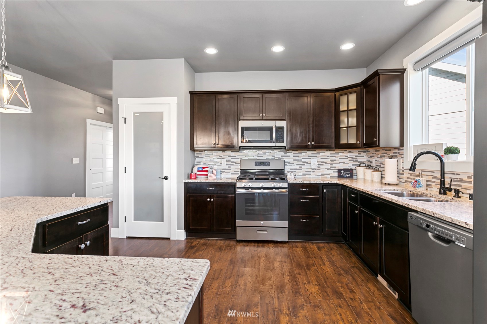 1002 Ridge Lane Everson, WA 98247 - Photo 8 of 38 a kitchen with stainless steel appliances kitchen island granite countertop a sink stove and refrigerator