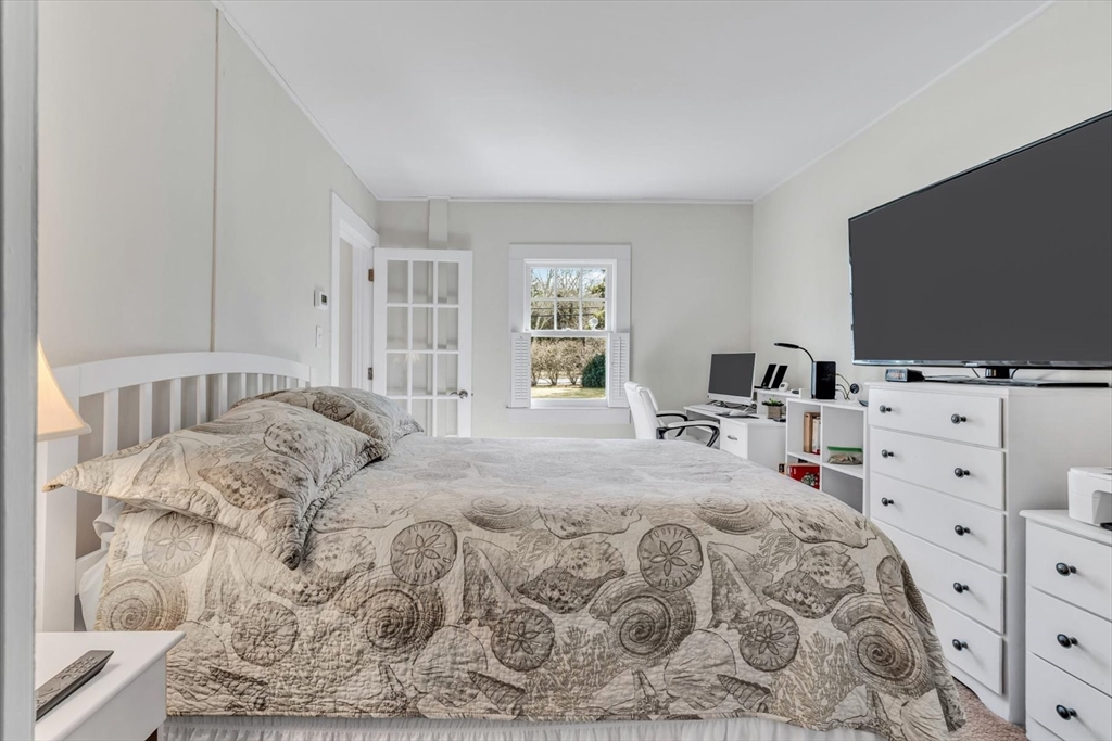 344 Main Street, Unit 5 Barnstable, MA 02632 - Photo 11 of 28 a bedroom with a bed and flat screen tv