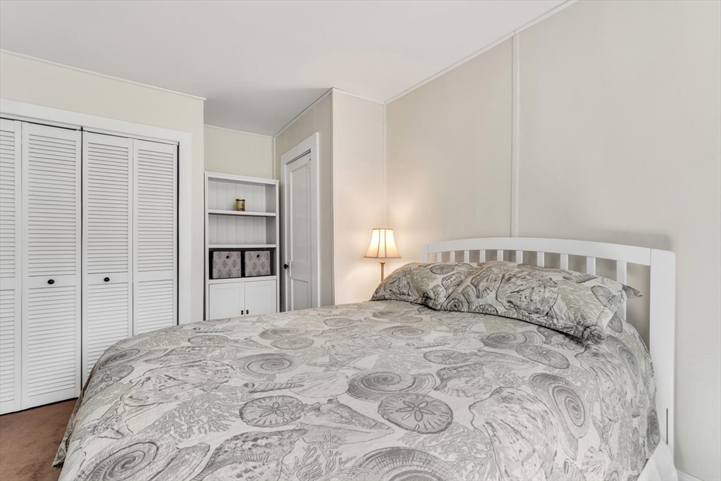 344 Main Street, Unit 5 Barnstable, MA 02632 - Photo 12 of 28 a bedroom with a large bed and a closet