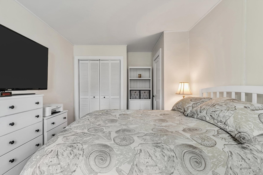 344 Main Street, Unit 5 Barnstable, MA 02632 - Photo 13 of 28 a bedroom with a bed and a flat screen tv