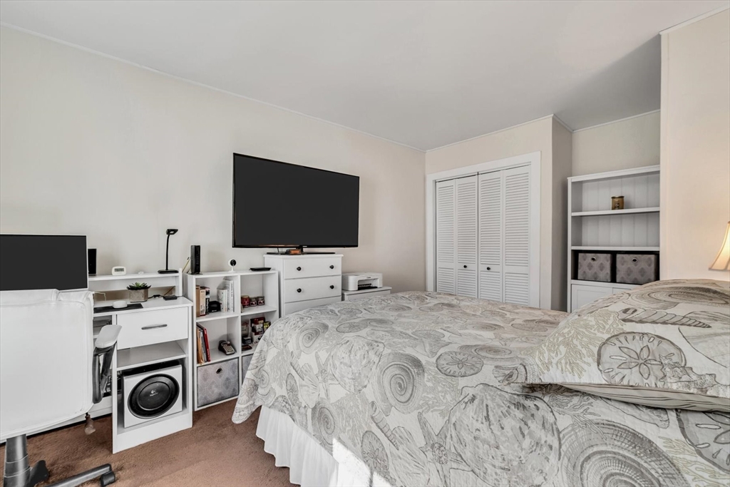 344 Main Street, Unit 5 Barnstable, MA 02632 - Photo 15 of 28 a bedroom with a bed and a flat screen tv