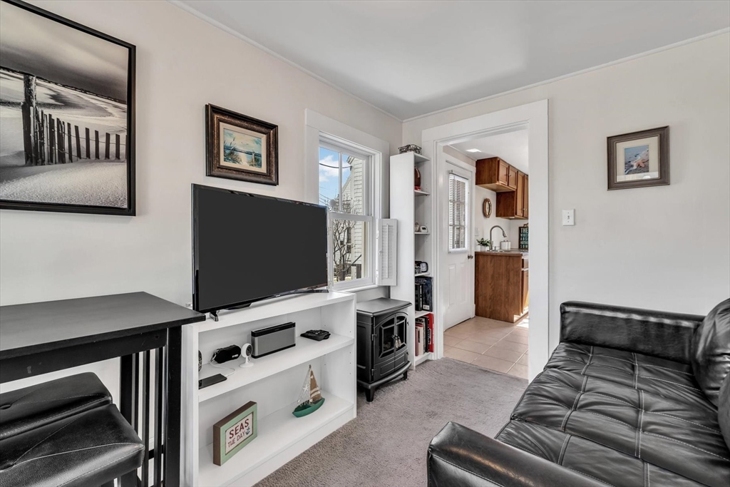 344 Main Street, Unit 5 Barnstable, MA 02632 - Photo 17 of 28 a living room with furniture and a flat screen tv