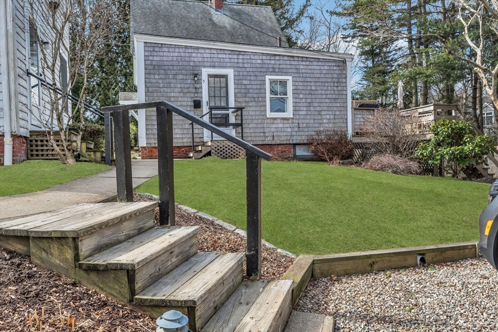 344 Main Street, Unit 5 Barnstable, MA 02632 - Photo 2 of 28 a view of a wooden deck and garden