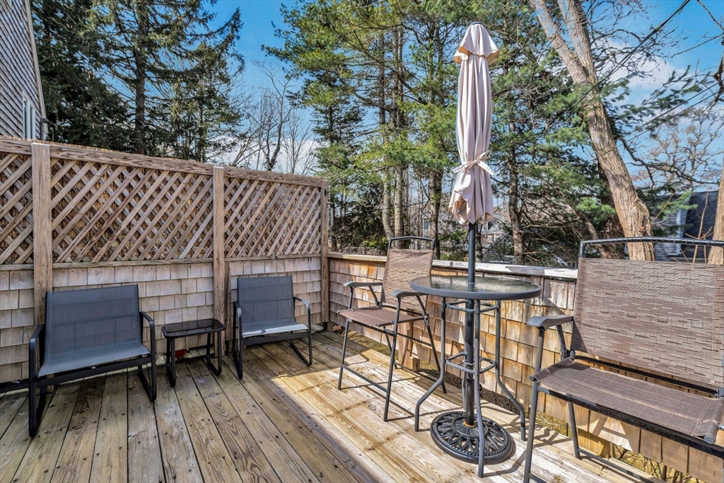 344 Main Street, Unit 5 Barnstable, MA 02632 - Photo 24 of 28 a view of a deck with furniture and trees