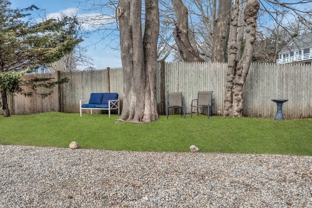 344 Main Street, Unit 5 Barnstable, MA 02632 - Photo 27 of 28 a backyard of a house with lots of green space