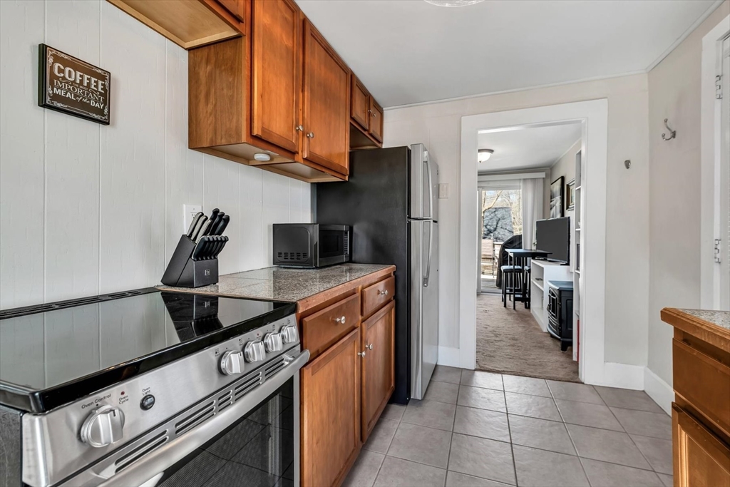 344 Main Street, Unit 5 Barnstable, MA 02632 - Photo 6 of 28 a kitchen with stainless steel appliances granite countertop a stove a refrigerator and a sink