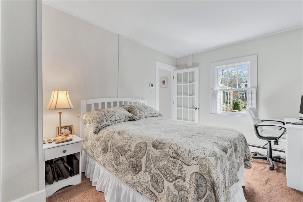 344 Main Street, Unit 5 Barnstable, MA 02632 - Photo 10 of 28 a bedroom with a bed and a window