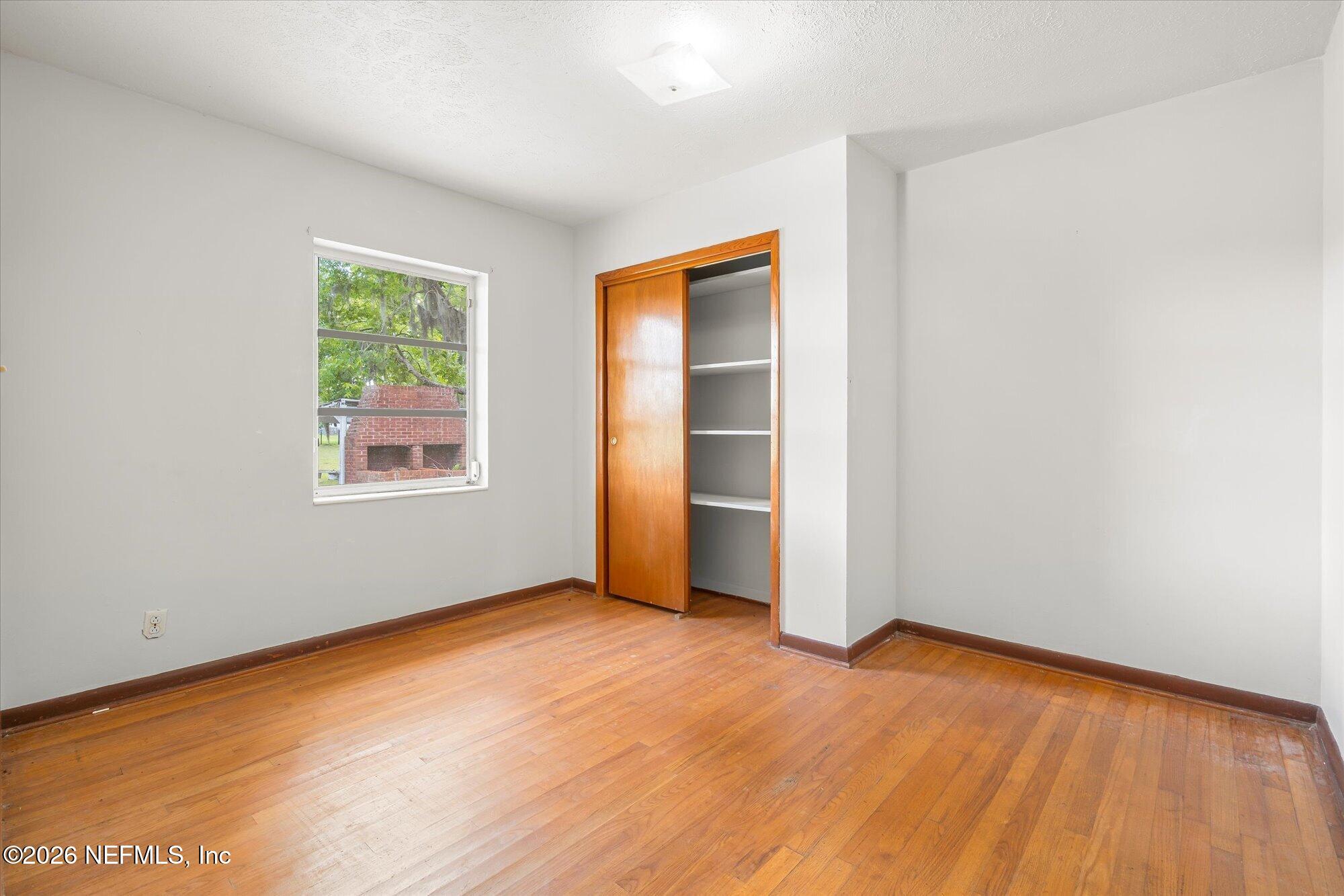 786 West River Road Palatka, FL 32177 - Photo 22 of 53 an empty room with wooden floor and windows