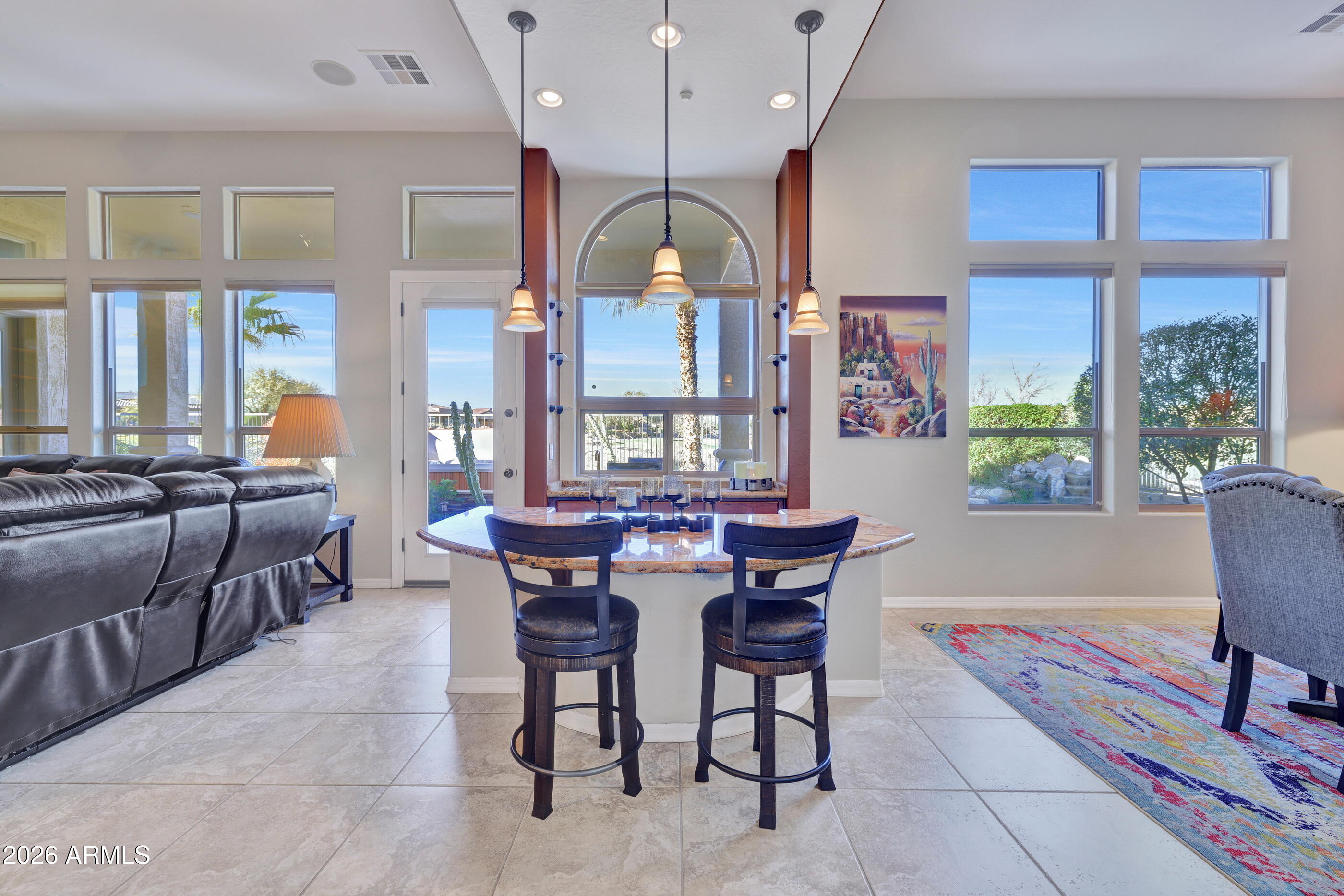 12510 West Bajada Road Peoria, AZ 85383 - Photo 16 of 84 a dining room with wooden floor a chandelier a wooden table and chairs