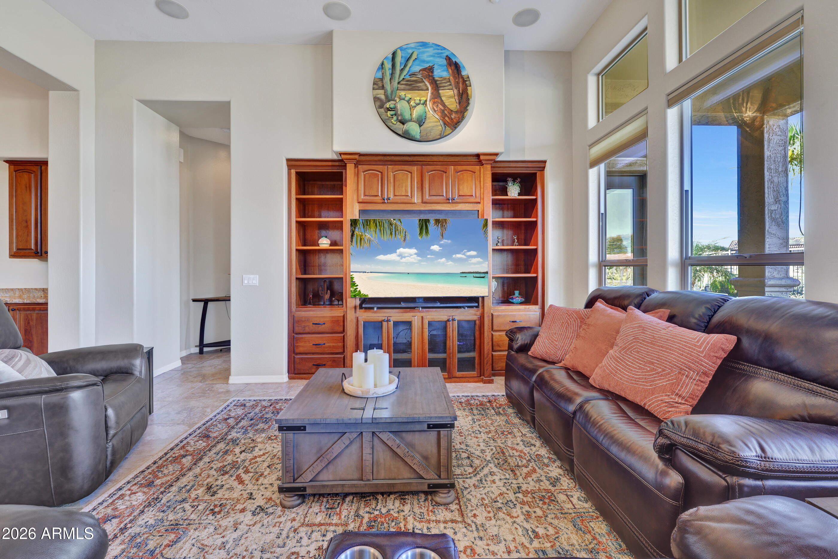 12510 West Bajada Road Peoria, AZ 85383 - Photo 18 of 84 a living room with furniture a fireplace and a large window