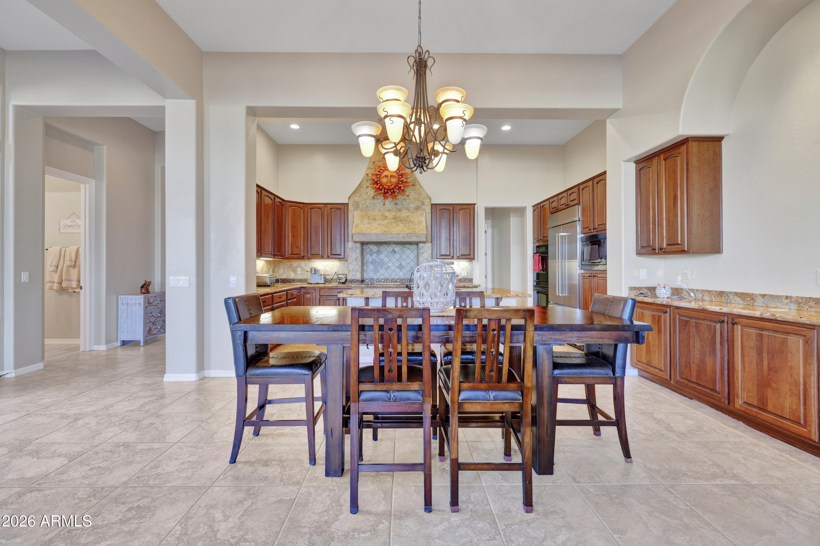 12510 West Bajada Road Peoria, AZ 85383 - Photo 25 of 84 a view of a dining room with furniture and chandelier