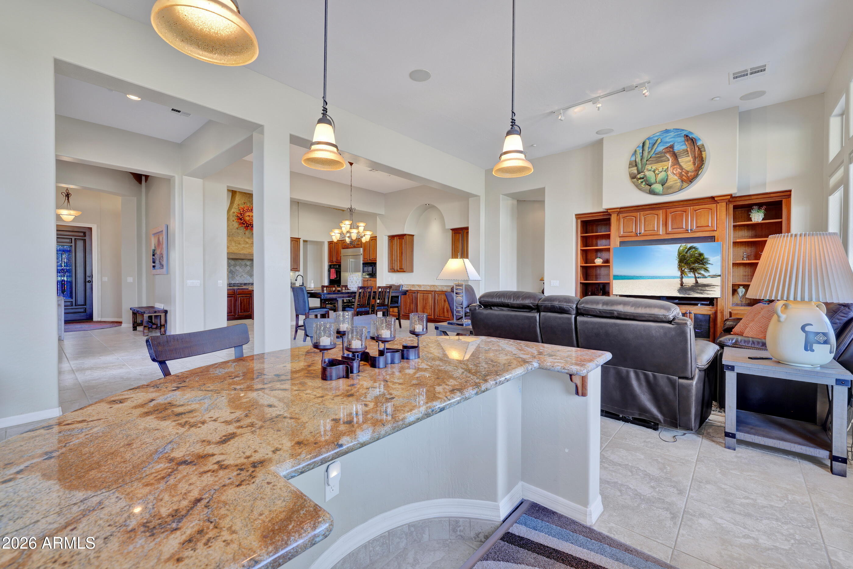 12510 West Bajada Road Peoria, AZ 85383 - Photo 27 of 84 a view of a dining room and livingroom with furniture wooden floor a chandelier
