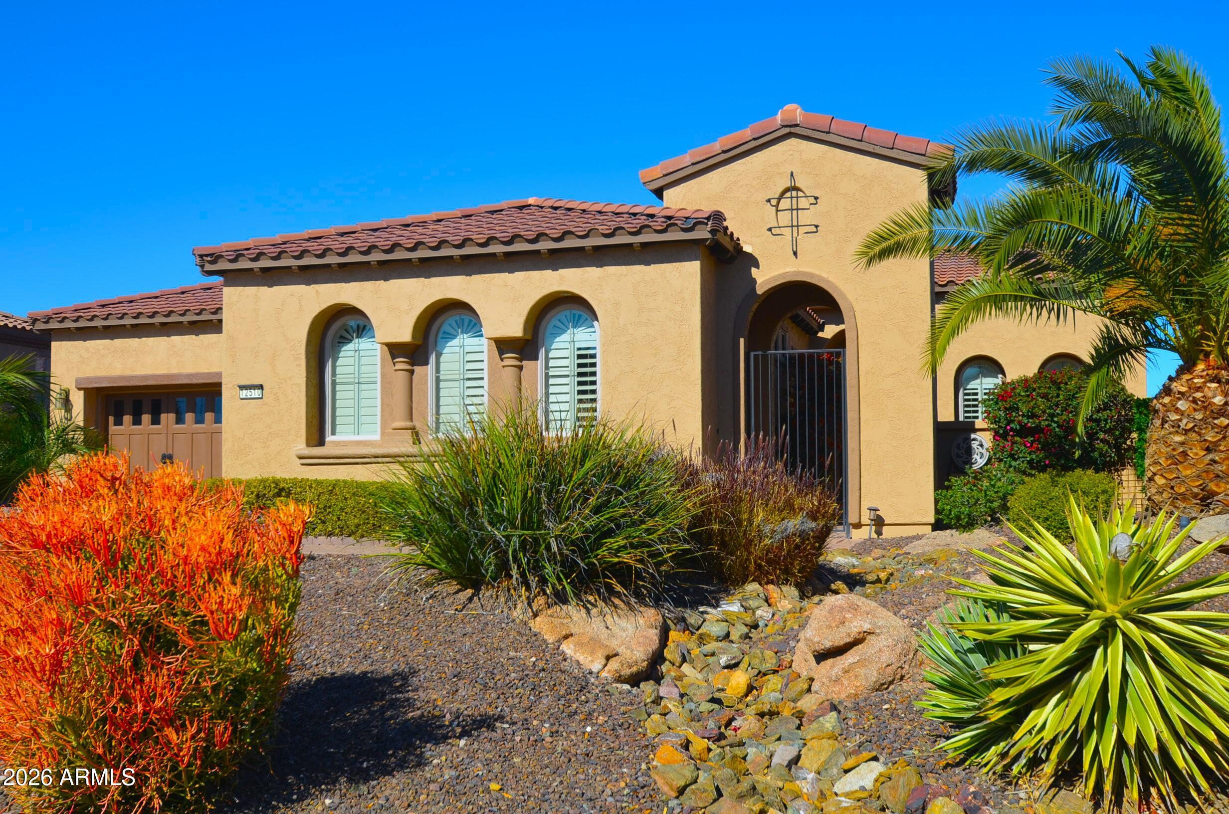 12510 West Bajada Road Peoria, AZ 85383 - Photo 2 of 84 a front view of a house with a garden