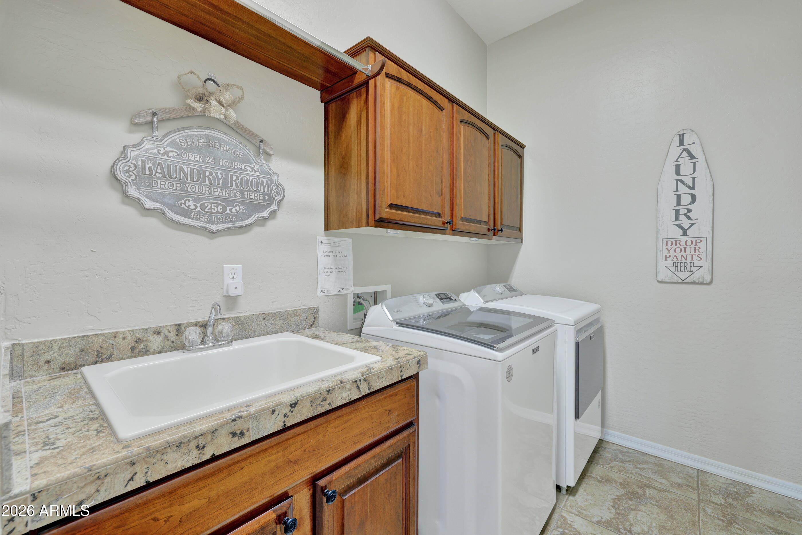 12510 West Bajada Road Peoria, AZ 85383 - Photo 39 of 84 a utility room with a sink a cabinets and entryway