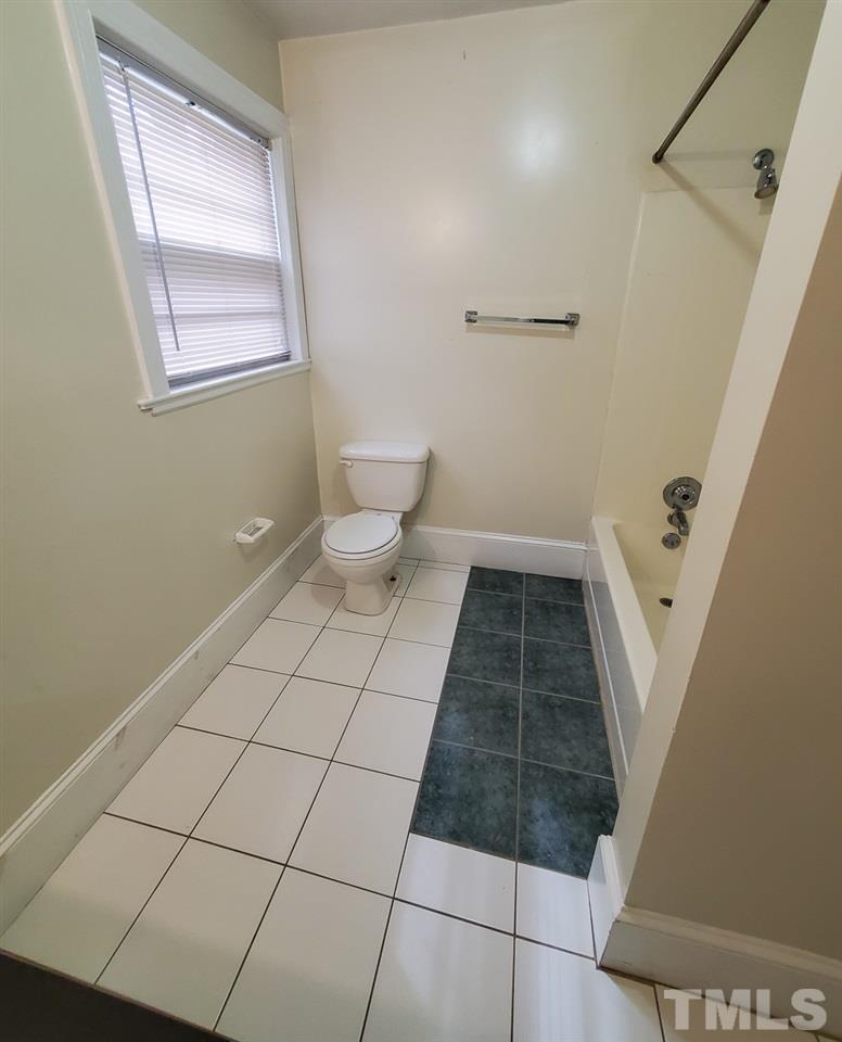 203 Jones Franklin Road Raleigh, NC 27606 - Photo 14 of 26 a bathroom with a sink a toilet and a mirror