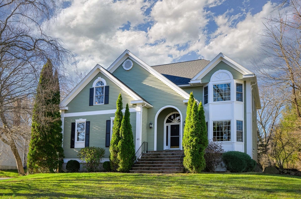 a view of a brick house with a yard