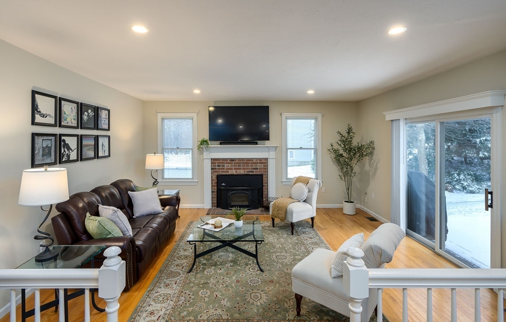 43 Edgewood Road Southborough, MA 01772 - Photo 12 of 36 a living room with furniture a flat screen tv and a fireplace