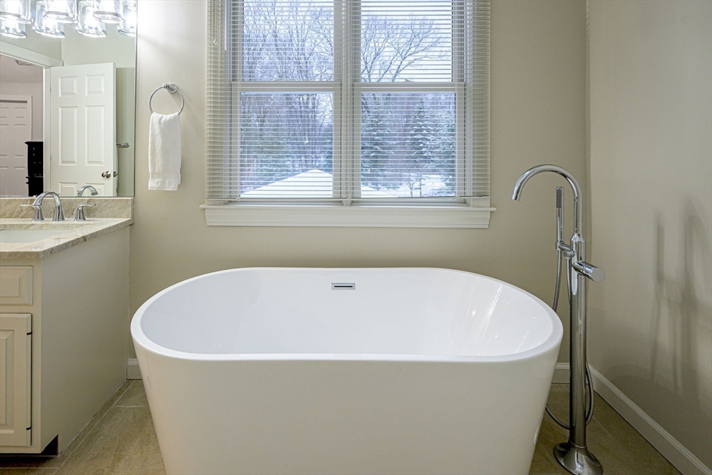 43 Edgewood Road Southborough, MA 01772 - Photo 21 of 36 a white bath tub sitting in a bathroom next to a window