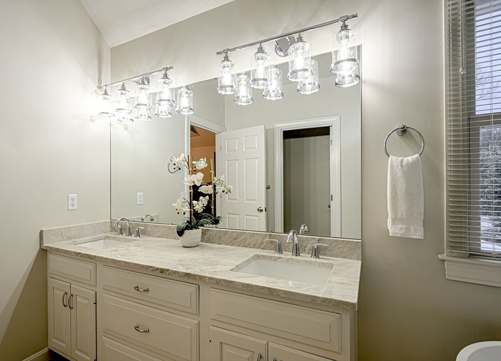 43 Edgewood Road Southborough, MA 01772 - Photo 22 of 36 a bathroom with a double vanity sink and a mirror