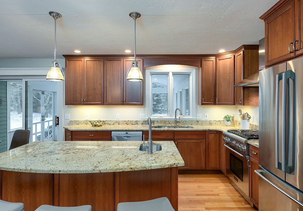 43 Edgewood Road Southborough, MA 01772 - Photo 7 of 36 a kitchen with kitchen island granite countertop a sink and a refrigerator