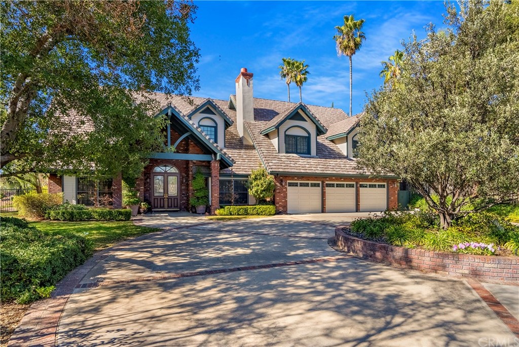 a front view of a house with a yard and outdoor seating