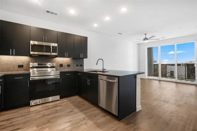 a kitchen with granite countertop a stove top oven and sink