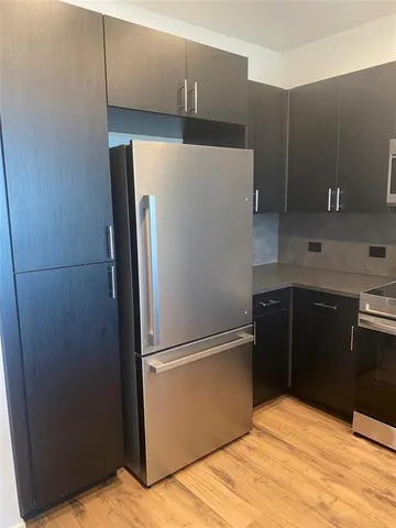 a kitchen with metallic refrigerator freezer and a dishwasher