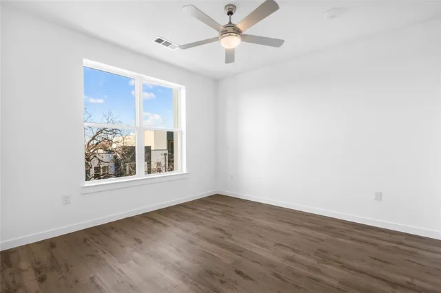 wooden floor in an empty room with a window