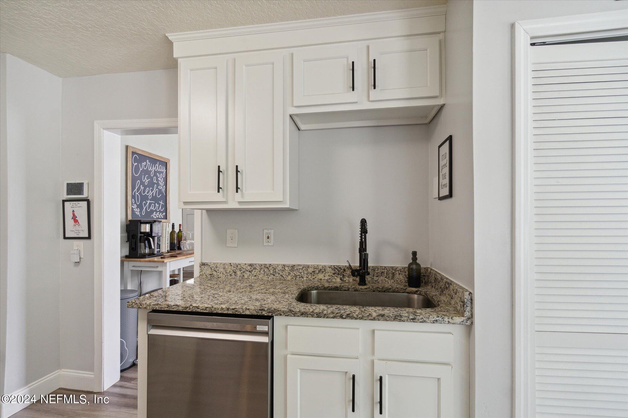 1262 Murray Drive Jacksonville, FL 32205 - Photo 20 of 42 a kitchen with granite countertop a sink and cabinets
